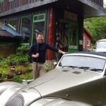 Gun engraver Vincent Crowley with a Morgan outside Malcolm Appleby's, © Armadillo Central, 2017 workshop