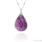 Henn of London Black Swan Pendant, front, hand carved amethyst, set in 18ct white gold with pavé set brilliant cut diamonds, with diamond eyes set in 18ct yellow gold