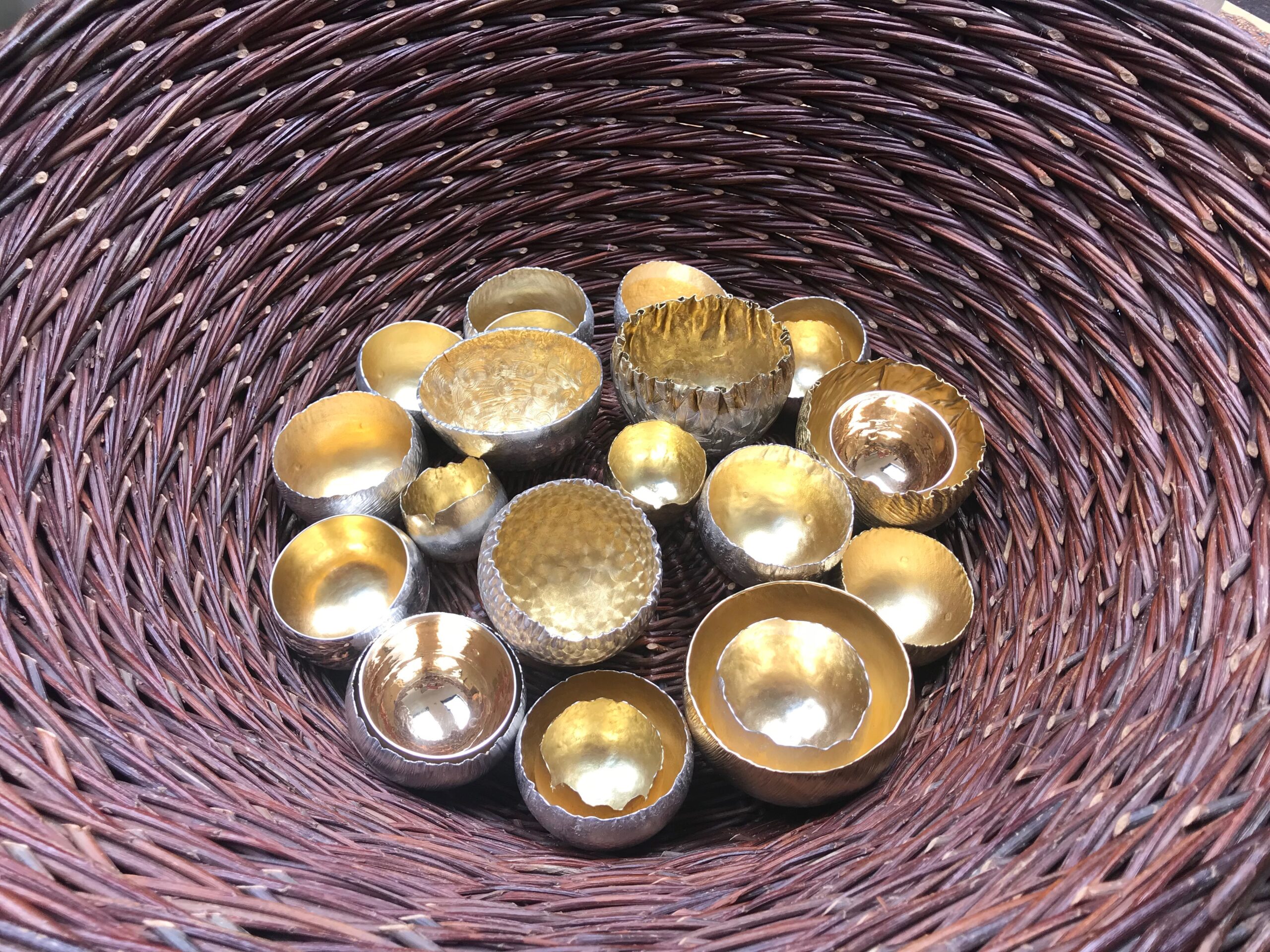 Lisa Bech Curly Weave Basket containing Malcolm Appleby beakers at the Silver Symposium, Grandtully, 2018 © The Scottish Gallery