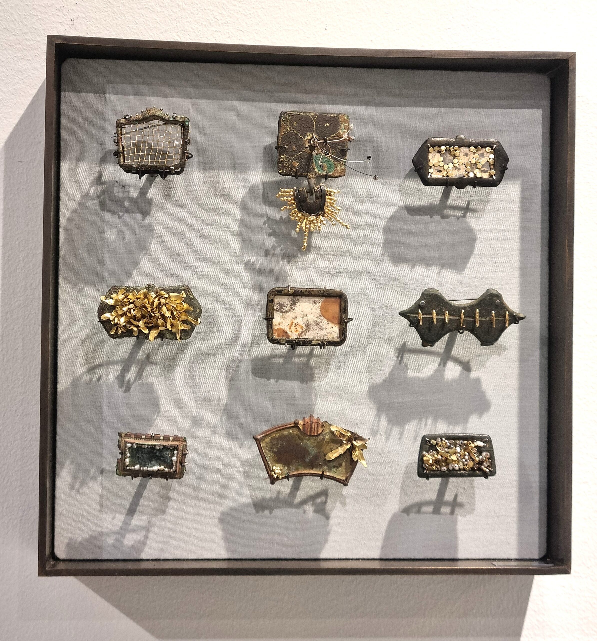 'and dead objects would acquire souls', nine metal detected finds transformed into brooches by Romilly Saumarez Smith, presented in a display box hand made by Lapsley Framewoks