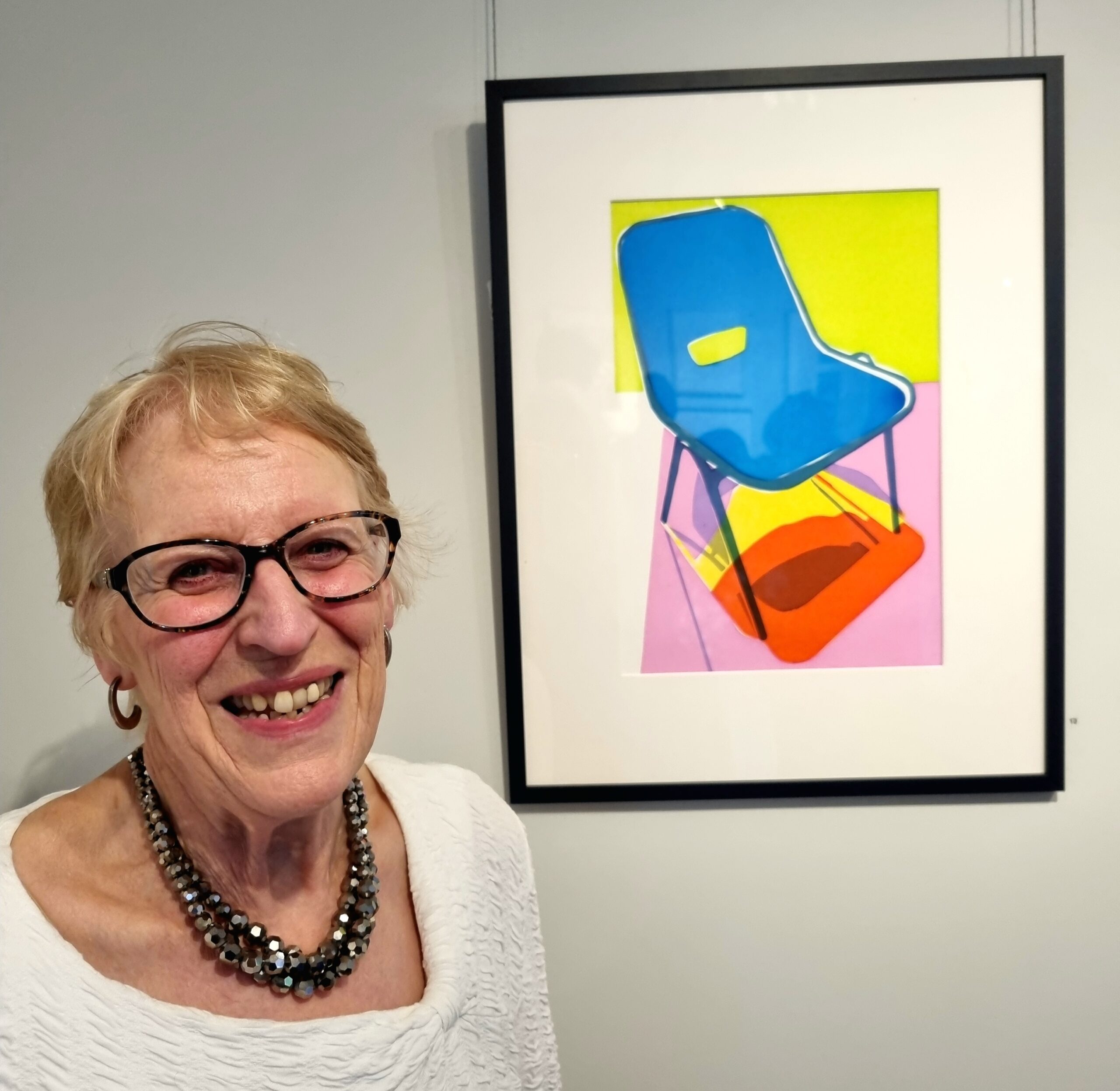 Elizabeth Jane Taylor, next to her 'Disco Chair' screenprint, portrait © Emma Boden 2026